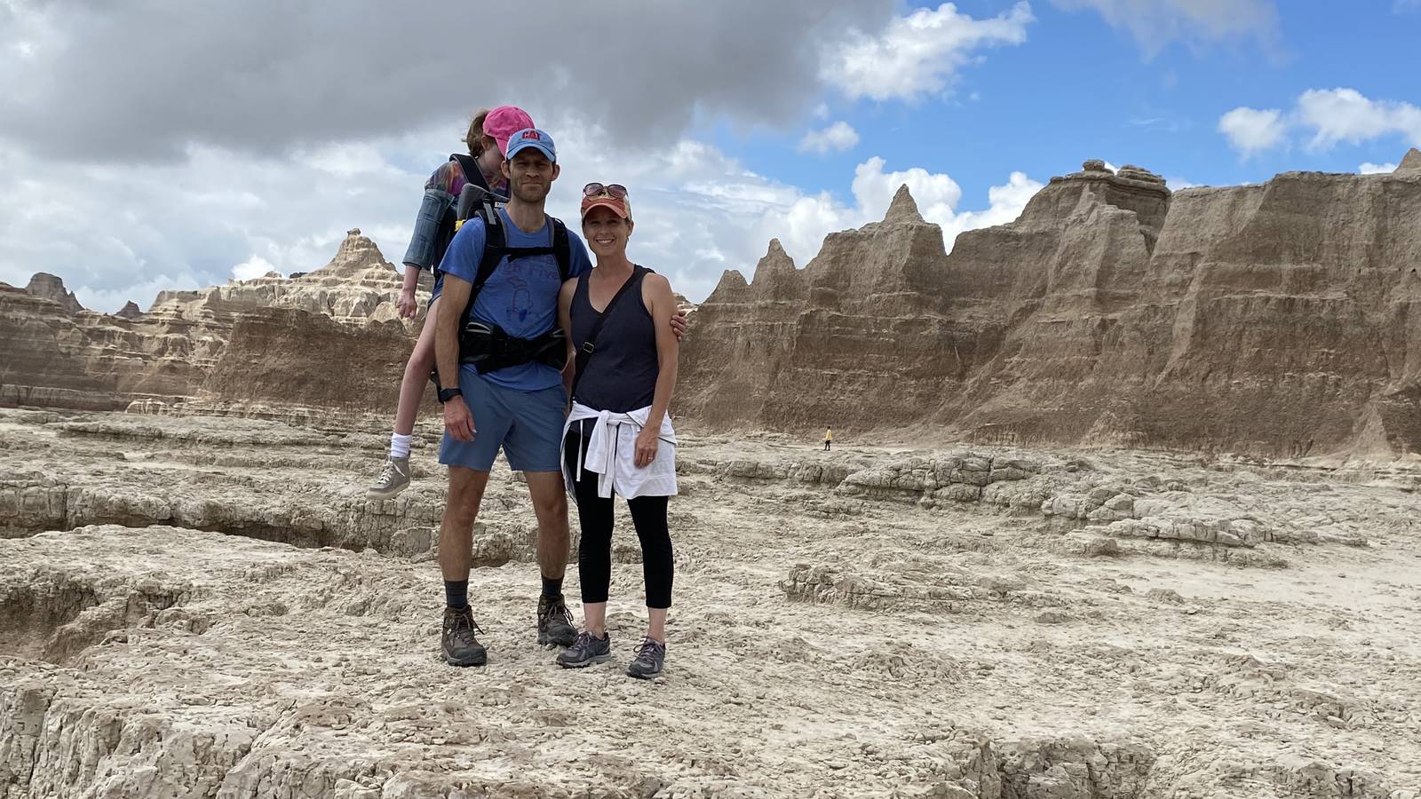 <p>John and Colleen Foster hike around Badlands National Park with their daughter Emmy.</p>