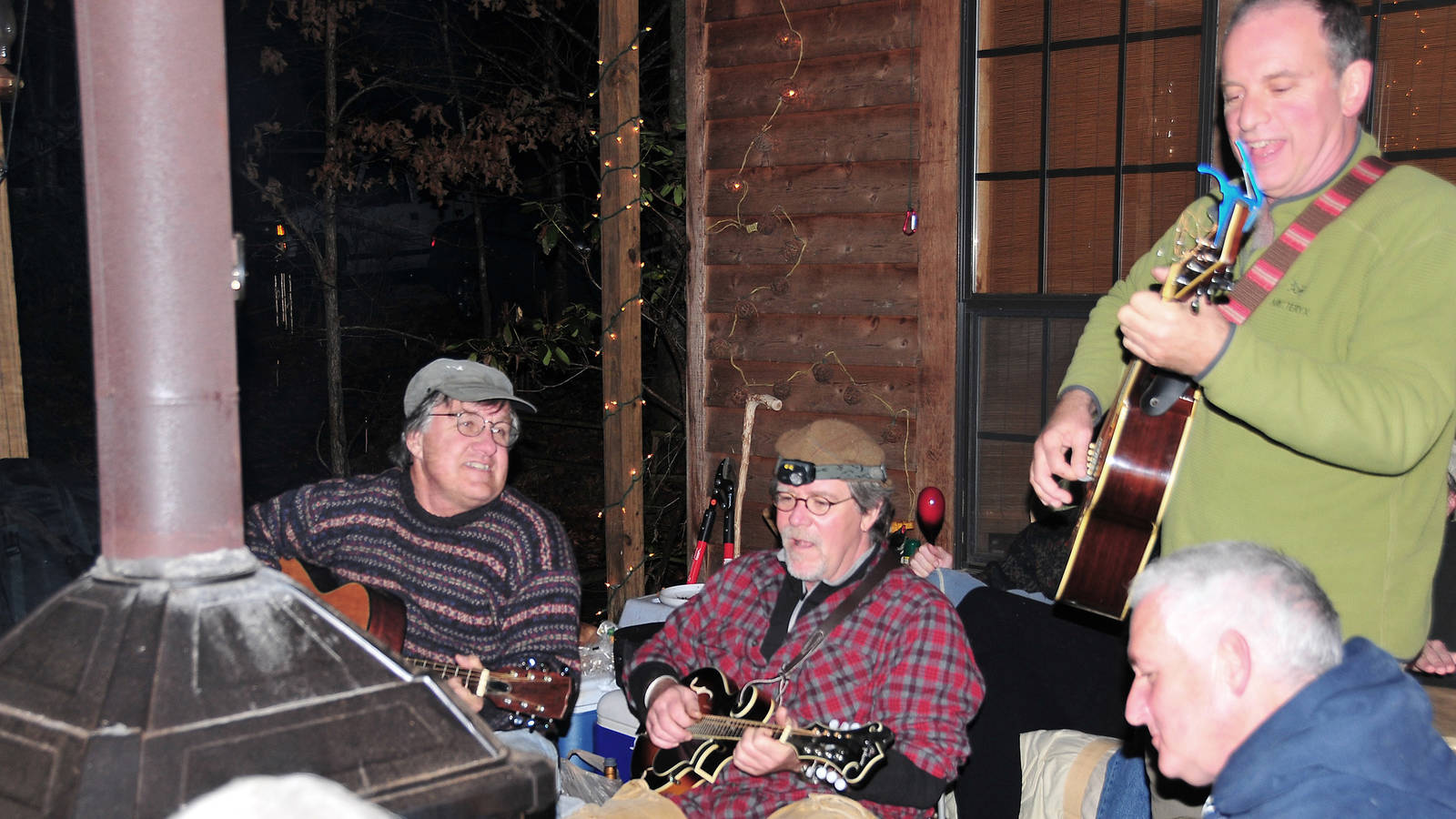 <p>The author and some friends stage a winter songfest in front of a fireplace on the cabin’s deck. </p>