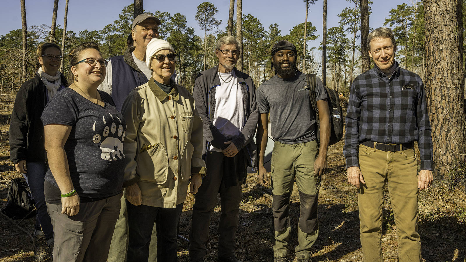 <p>Volunteers pose after a day of longleaf pine planting in February 2022.</p>