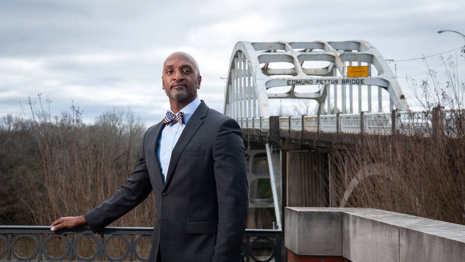 <p>Phillip Howard stands near the Edmund Pettus Bridge. Howard, a project manager at The Conservation Fund, has spent the last two years working to preserve the nearly forgotten homes and campsites used by protesters who marched from Selma to Montgomery in 1965. </p>