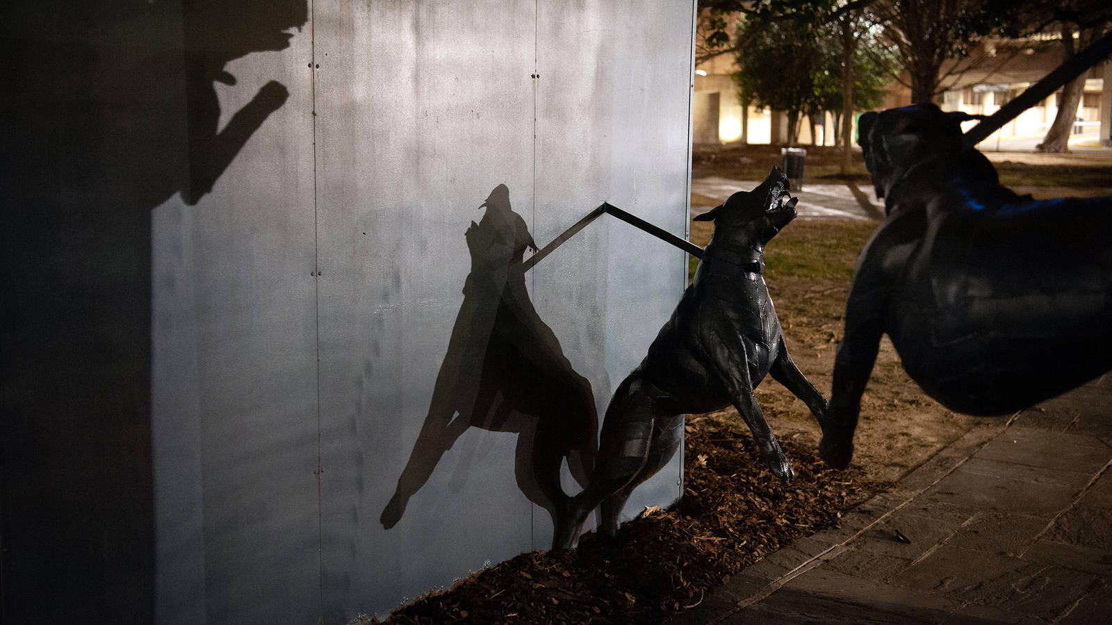 <p>Scrap iron police dogs created by artist James Drake lunge across a walkway in Kelly Ingram Park. Police used attack dogs, fire hoses, tear gas and clubs to disrupt civil rights demonstrations in the 1960s. Thousands of peaceful protesters were arrested and jailed, including more than 600 children.</p>