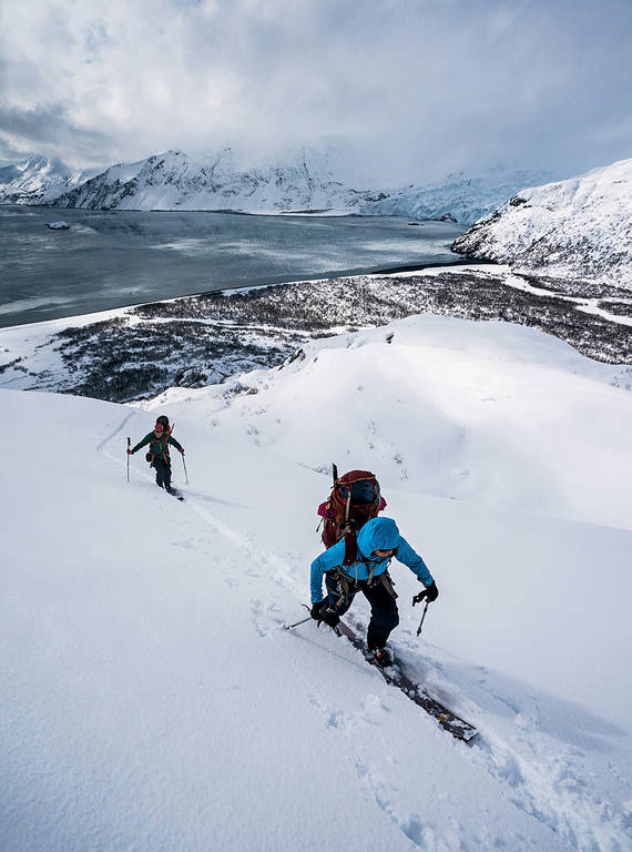<p>Partners Erin Griffith and Jacob Chaney (in blue), who are both registered paramedics and wildland firefighters, ascend a slope by Aialik Bay.</p>