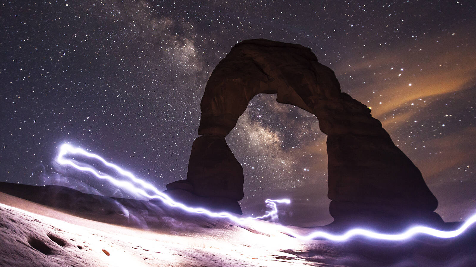 <p>Frank invested in some lenses designed specifically for nighttime shooting and tested them in his backyard. After he saw that the new equipment worked, he hiked up to Delicate Arch in Arches National Park and captured this image of the Milky Way. His headlamp is responsible for the otherworldly streak.</p>