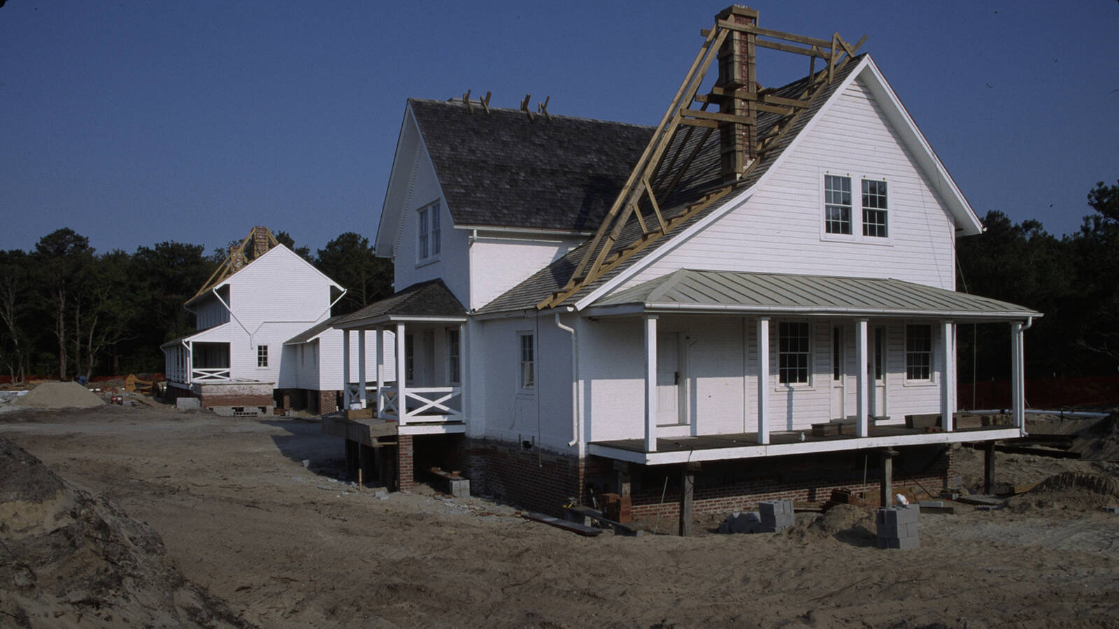 <p>The Principal Keeper's Quarters and Double Keepers' Quarters atop new pilings and foundations at the new site for the Cape Hatteras Light Station on June 3, 1999. </p>