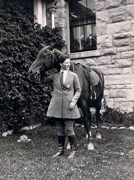 <p>Lindsley in her ranger uniform with Rex, the horse.</p>