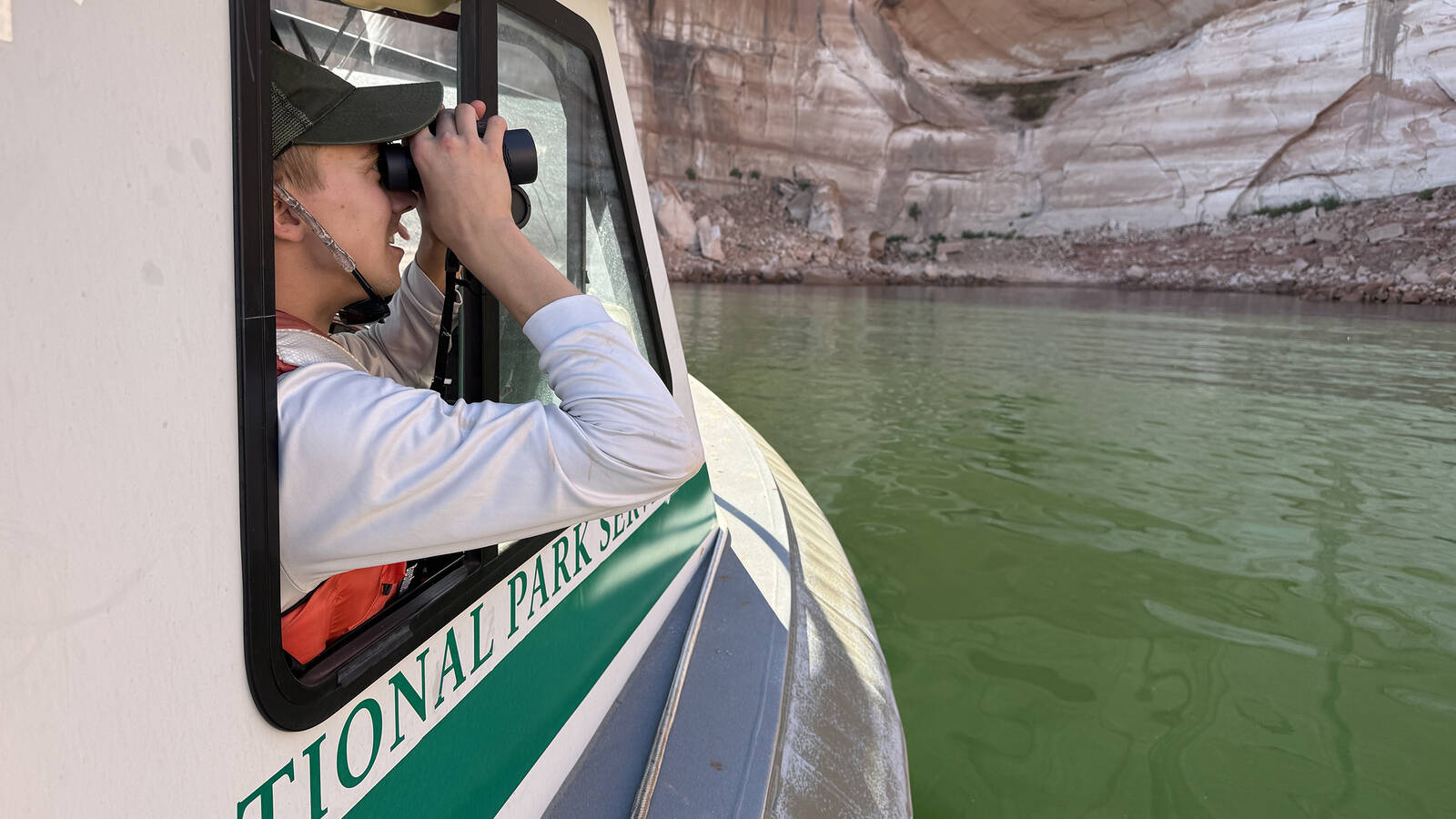 <p>Anderson searches for graffiti from the cabin of the GRIT boat. </p>