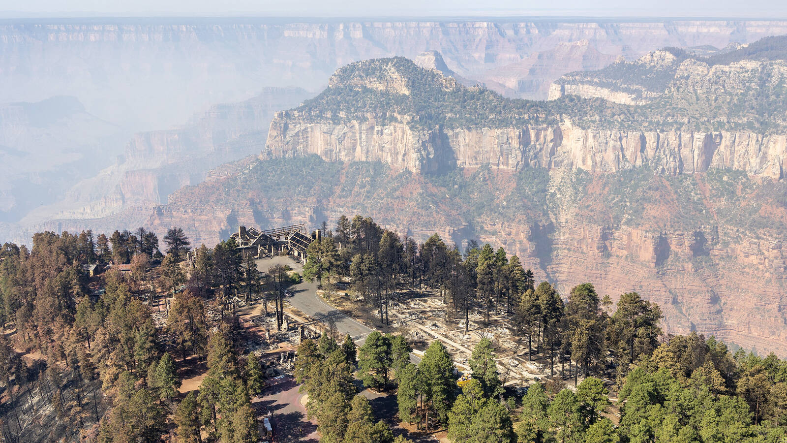 <p>Above Grand Canyon Lodge and the southern terminus of Arizona State Route 67 in the North Rim developed area. The remains of Grand Canyon Lodge are visible at left. The Dragon Bravo Fire passed through this location July 12-13, 2025. </p>