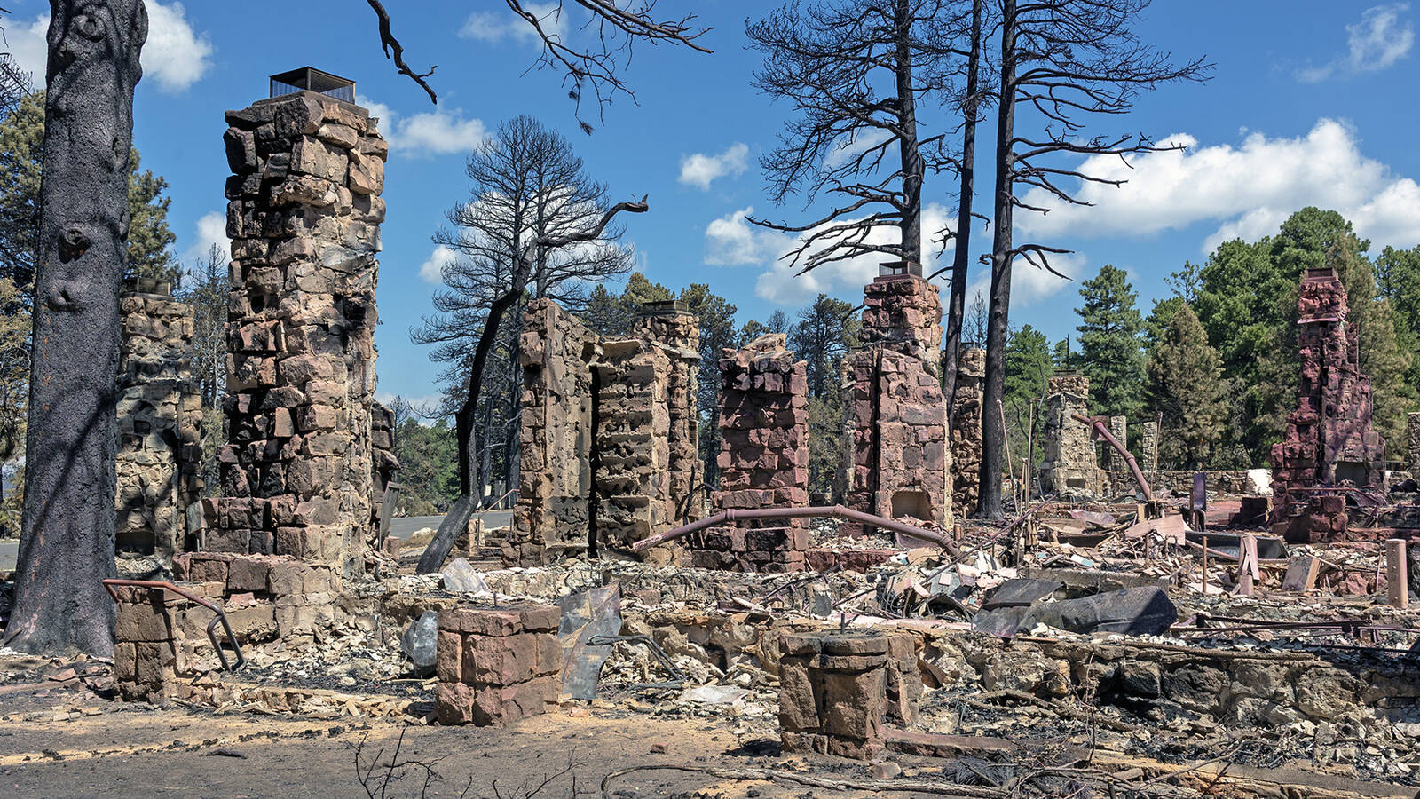 <p>Stone chimneys remaining from Grand Canyon Lodge deluxe cabins that burned when the Dragon Bravo Fire passed through July 12-13, 2025. </p>