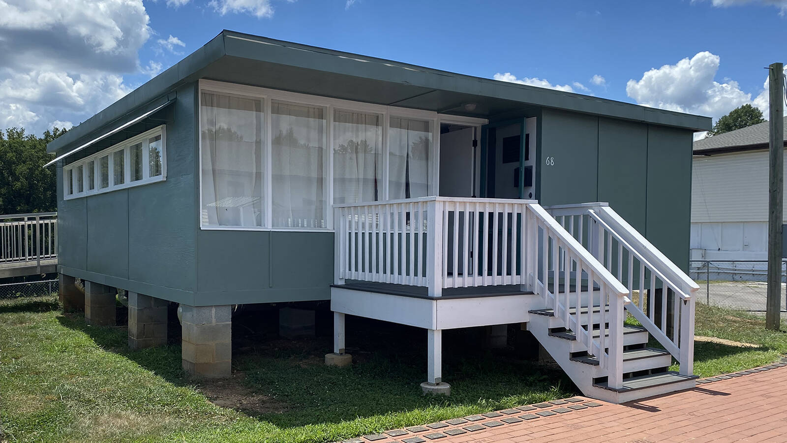 <p>Hastily constructed in 1942, Oak Ridge grew to 75,000 residents during World War II. During peak construction, the U.S. government installed 1,000 prefabricated homes every month, such as this B-1 model.</p>