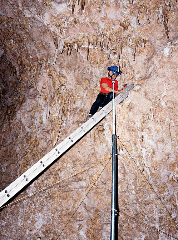 <p>Mansur prepares the stalactijack max, a MacGyvered piece of cave repair equipment, in Carlsbad Caverns National Park.</p>