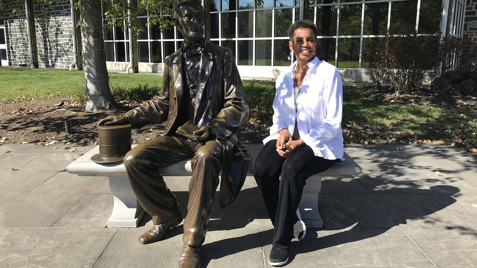 <p>Former Congresswoman Donna Edwards seated with a statue of President Abraham Lincoln at Gettysburg National Military Park. </p>