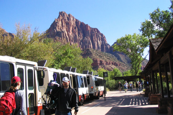 Passengers board the free shuttle at the Zion National Park visitor center.